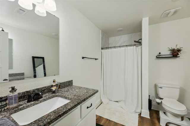 bathroom with a shower with curtain, vanity, hardwood / wood-style floors, and toilet