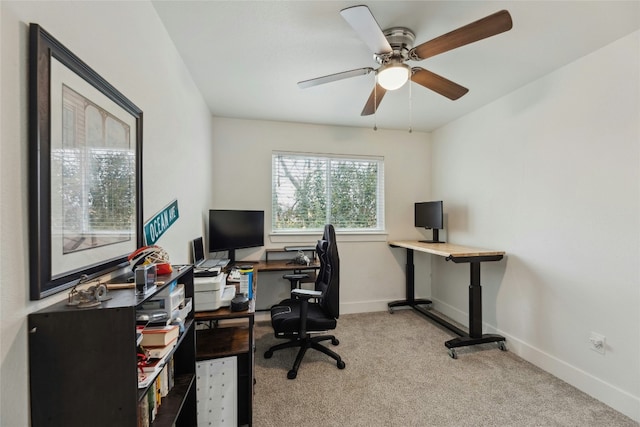 carpeted office featuring ceiling fan
