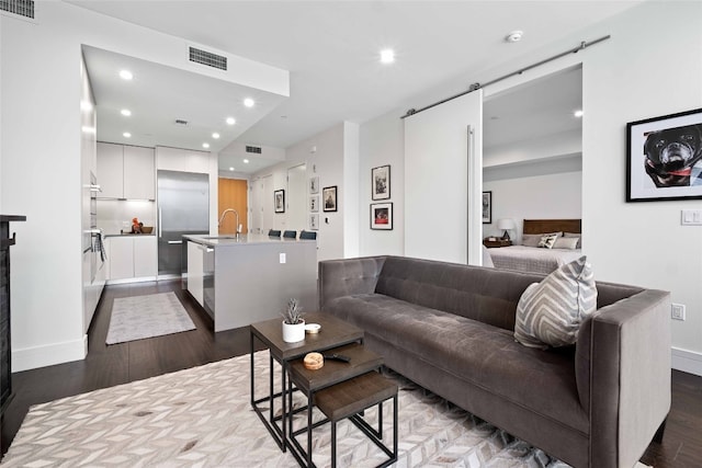 501 W Ave Unit 1403, Austin, TX 78701 - living room featuring a barn door, recessed lighting, and dark wood-style flooring