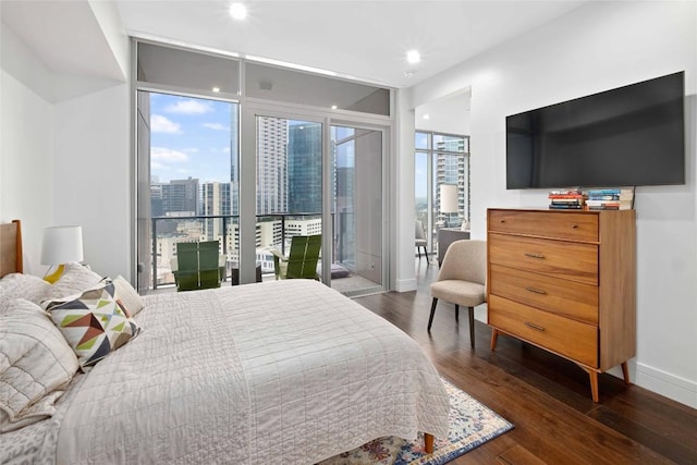 bedroom with expansive windows, access to exterior, and dark wood-type flooring