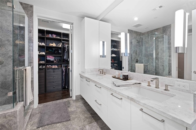 bathroom featuring vanity and an enclosed shower