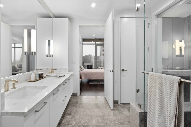 501 W Ave Unit 1403, Austin, TX 78701 - bathroom with ensuite bath, double vanity, healthy amount of natural light, and recessed lighting