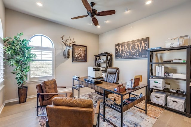 office space with light wood-type flooring and ceiling fan