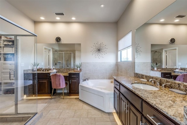 bathroom with tile patterned flooring, vanity, and separate shower and tub