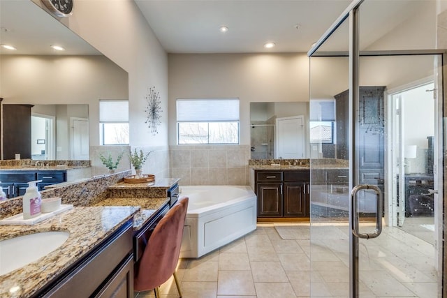 bathroom featuring vanity, separate shower and tub, and tile patterned floors