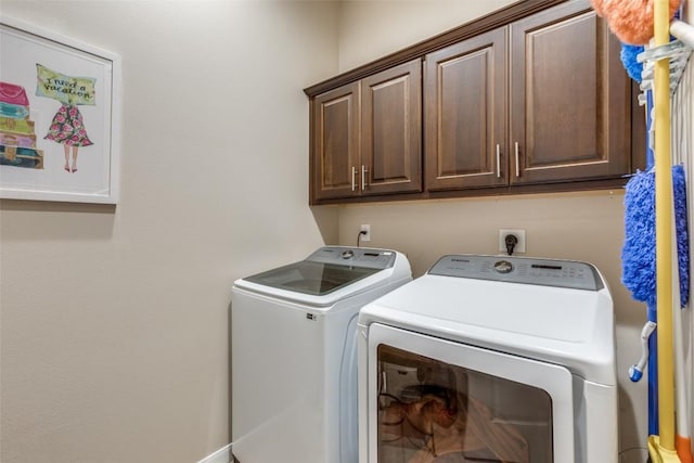 washroom featuring cabinets and independent washer and dryer