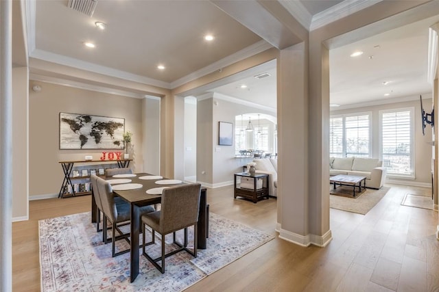 dining room featuring crown molding and light wood-type flooring