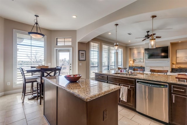 kitchen with pendant lighting, sink, dishwasher, a kitchen island with sink, and dark brown cabinetry