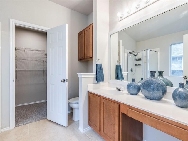 bathroom with vanity, toilet, an enclosed shower, and tile patterned flooring