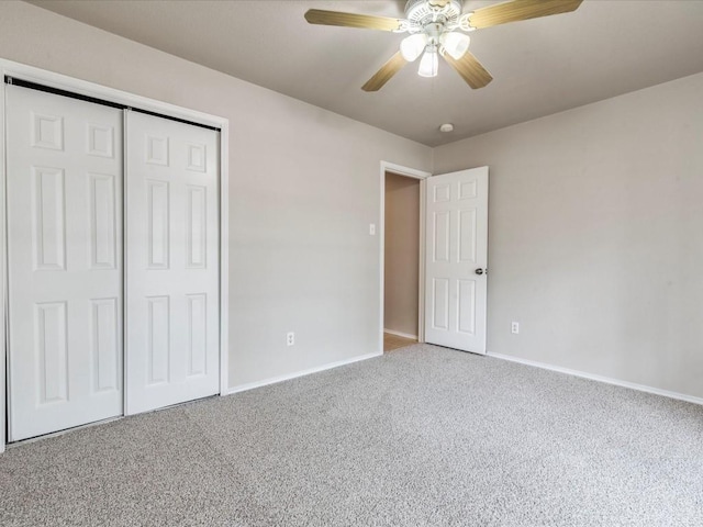 unfurnished bedroom featuring ceiling fan, a closet, and carpet