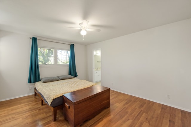 bedroom featuring hardwood / wood-style floors, ensuite bath, and ceiling fan