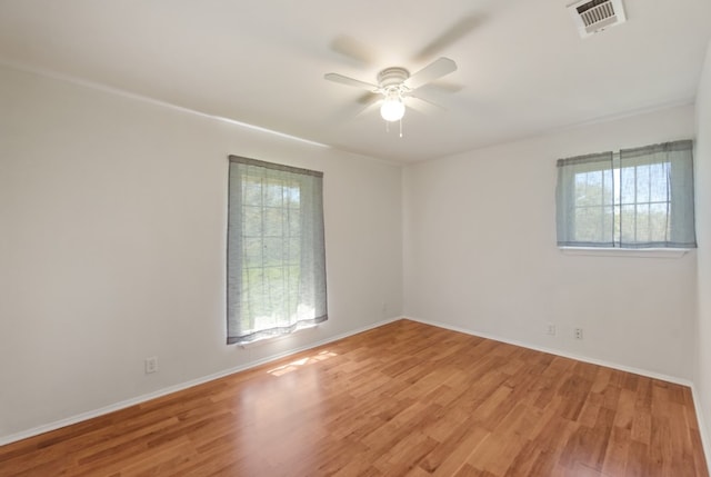 spare room featuring ceiling fan and light wood-type flooring