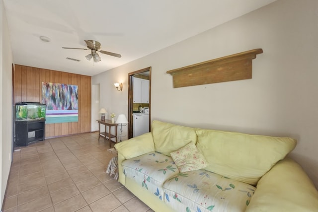 tiled living room with ceiling fan