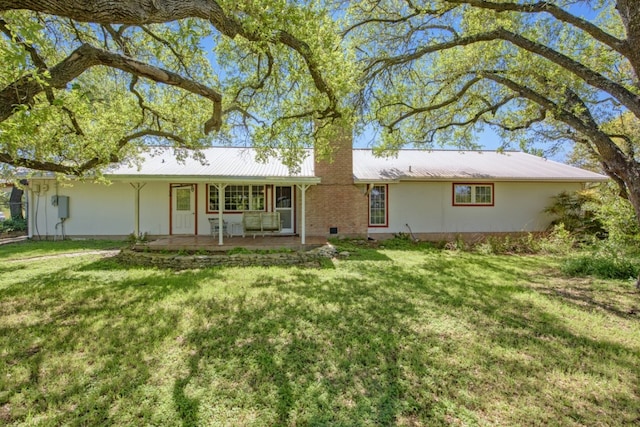 9304 Rock Way Dr, Austin, TX 78736 - rear view of property featuring a chimney, a lawn, metal roof, and covered porch