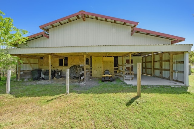 rear view of property featuring an outdoor structure