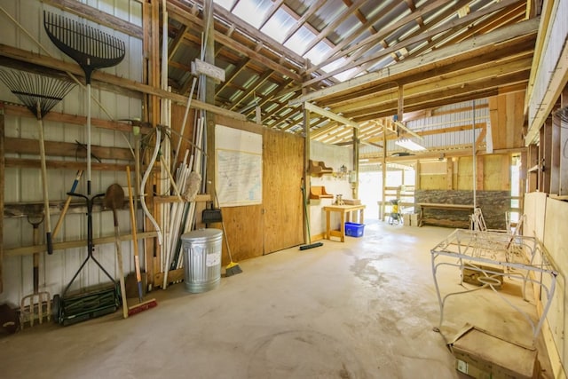 miscellaneous room with vaulted ceiling and concrete floors