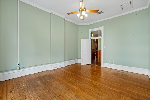 empty room with crown molding, ceiling fan, and wood-type flooring