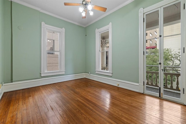 spare room featuring hardwood / wood-style flooring, ornamental molding, ceiling fan, and baseboard heating