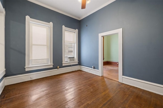 spare room featuring crown molding, a baseboard heating unit, hardwood / wood-style floors, and ceiling fan