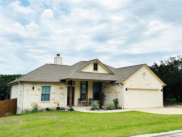 ranch-style home with covered porch, a garage, and a front yard