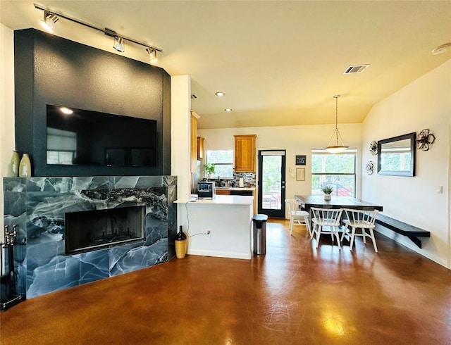 living room with lofted ceiling and a fireplace