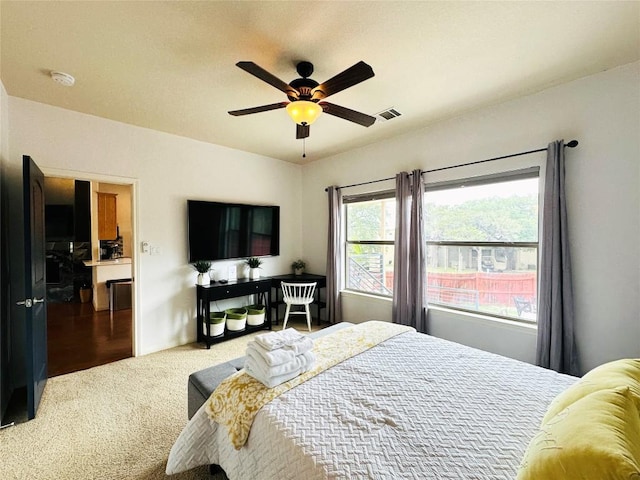 bedroom featuring ceiling fan and carpet