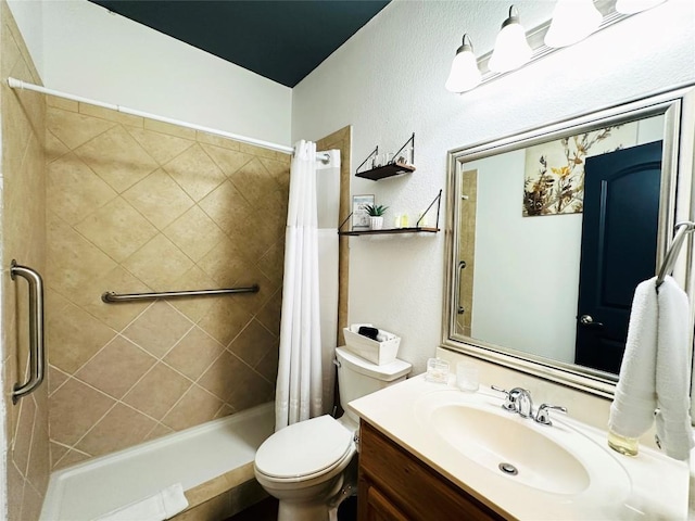 bathroom featuring toilet, vanity, and walk in shower