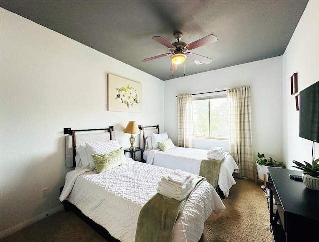 bedroom with dark colored carpet and ceiling fan