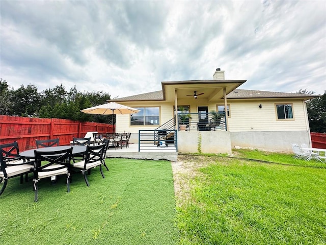 back of house with a yard and a patio area