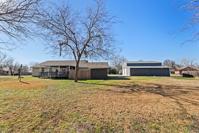 rear view of property with a wooden deck and a yard