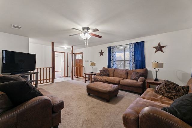 carpeted living room with ceiling fan