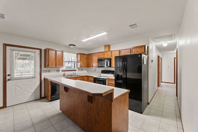 kitchen with a center island, light tile patterned floors, a kitchen bar, and black appliances