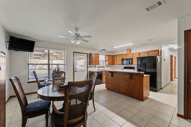 tiled dining room with ceiling fan