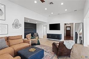 living room with ceiling fan and light hardwood / wood-style floors