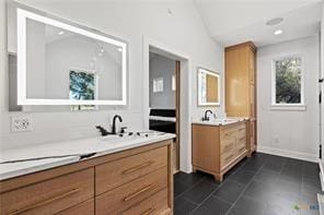 bathroom featuring vaulted ceiling, vanity, and tile patterned flooring