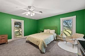 carpeted bedroom with ceiling fan