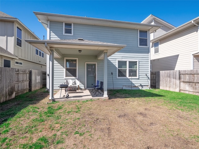 rear view of property featuring a yard and a patio