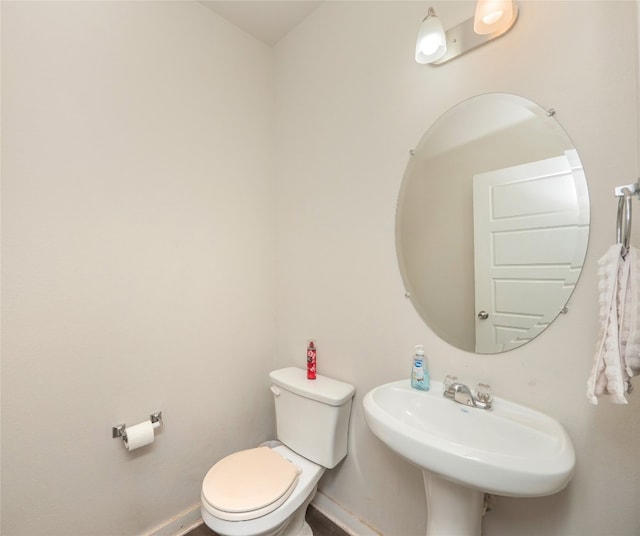 bathroom featuring toilet and sink