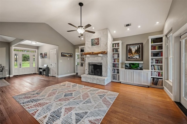 unfurnished living room with lofted ceiling, a fireplace, and light hardwood / wood-style floors