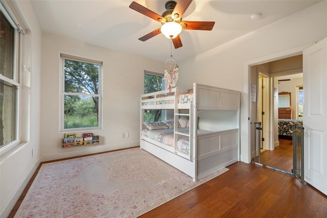 unfurnished bedroom with dark hardwood / wood-style floors and ceiling fan