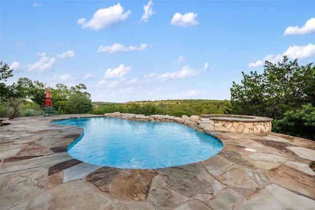 view of swimming pool featuring a patio and an in ground hot tub