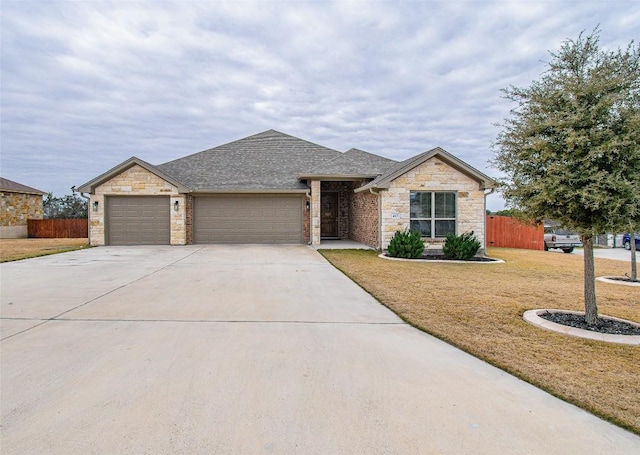 view of front of house featuring a garage and a front lawn