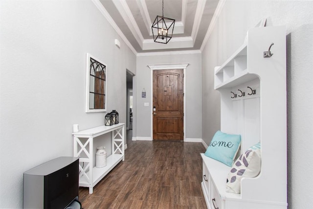 mudroom with dark hardwood / wood-style floors, ornamental molding, a tray ceiling, and an inviting chandelier