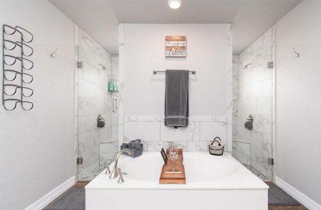 bathroom with independent shower and bath and wood-type flooring