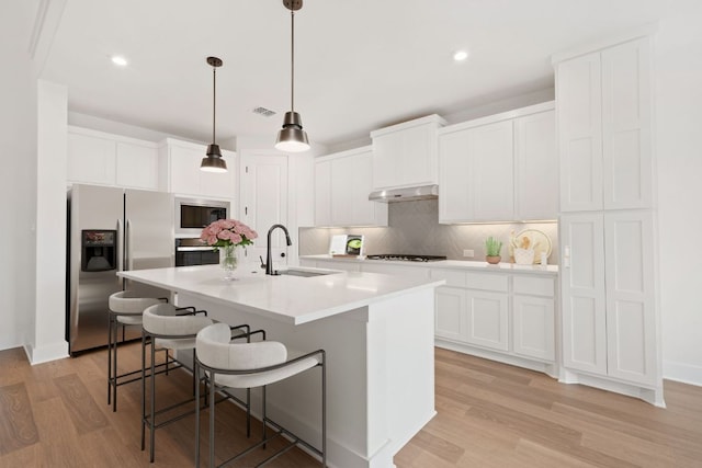 1243 Robin Trl, Round Rock, TX 78681 - kitchen featuring stainless steel refrigerator with ice dispenser, extractor fan, a sink, oven, and light wood finished floors