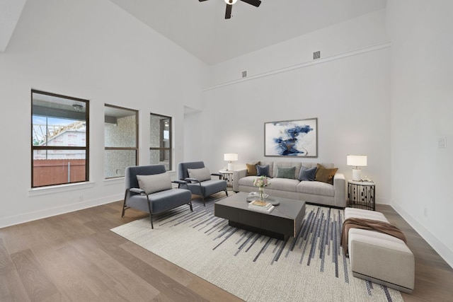 1243 Robin Trl, Round Rock, TX 78681 - living area with wood finished floors, ceiling fan, a towering ceiling, and baseboards