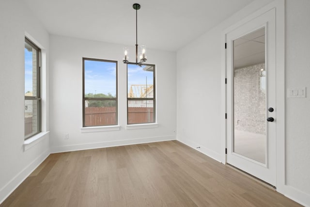 1243 Robin Trl, Round Rock, TX 78681 - unfurnished dining area with a chandelier, wood finished floors, and baseboards