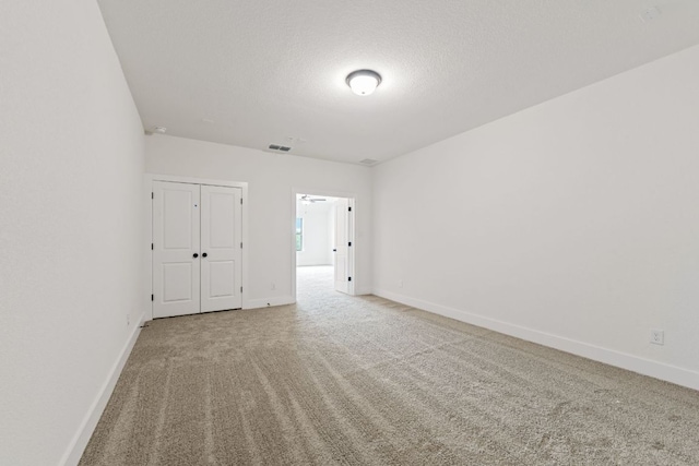 1243 Robin Trl, Round Rock, TX 78681 - unfurnished bedroom with light colored carpet, a closet, and a textured ceiling