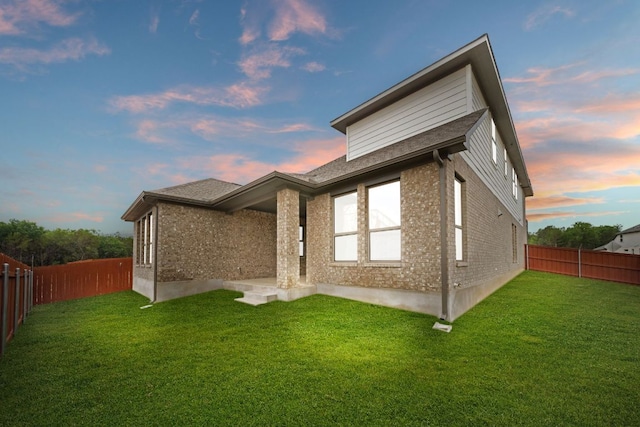 1243 Robin Trl, Round Rock, TX 78681 - back of house at dusk with brick siding and a fenced backyard