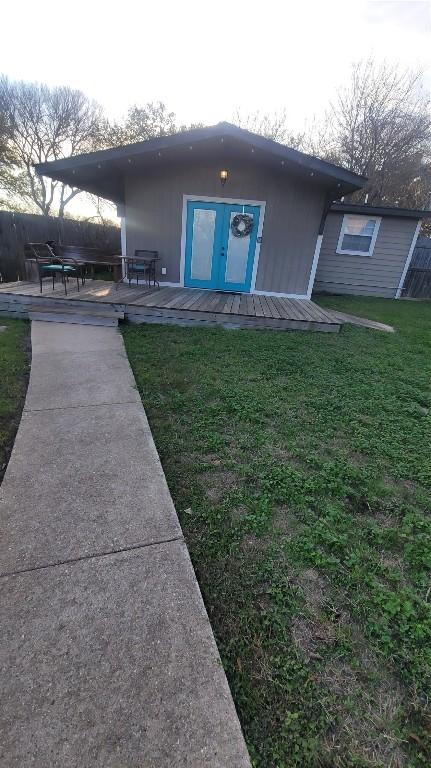 rear view of house featuring a lawn and a patio